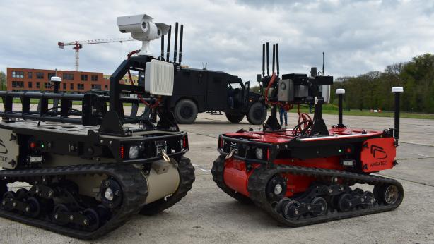Both Angatec's bots with Arquus' Sherpa Light APC in background during testing at Satory.